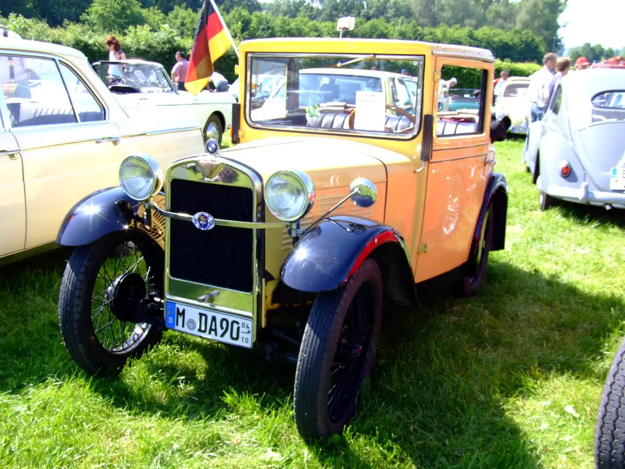 A yellow BMW 3/15 Dixi from 1930 at a classic-car meeting
