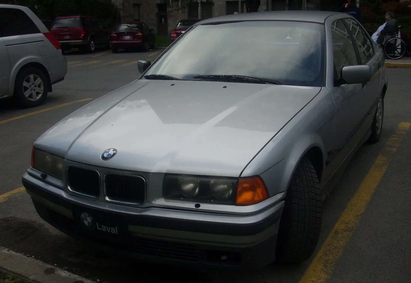 A silver BMW E36 3 Series four-door saloon of the early 1990s