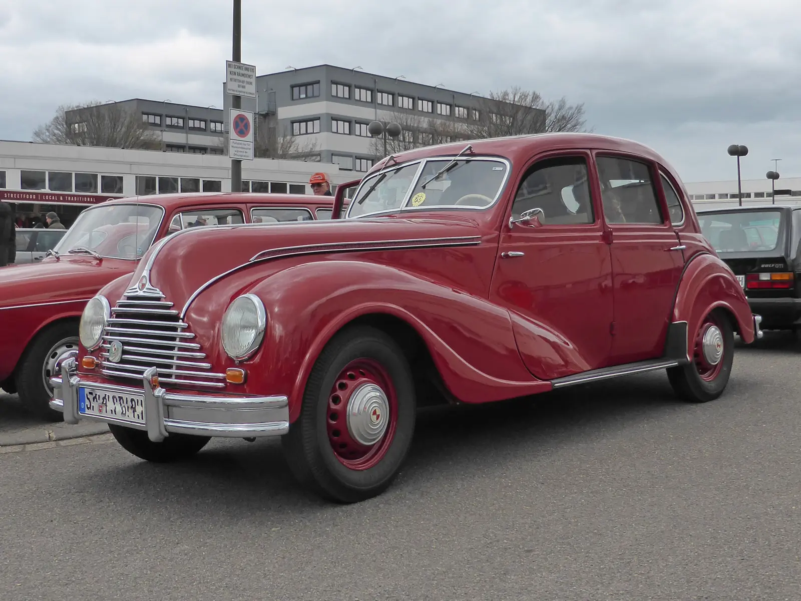 A dark red EMW 340 saloon at a classic-car event